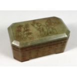 A CHINESE JADE BOX AND COVER, incised with figures and calligraphy. 5.5ins long.
