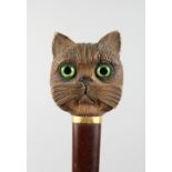 A GOOD CARVED CAT'S HEAD WALKING STICK HANDLE with glass eyes.