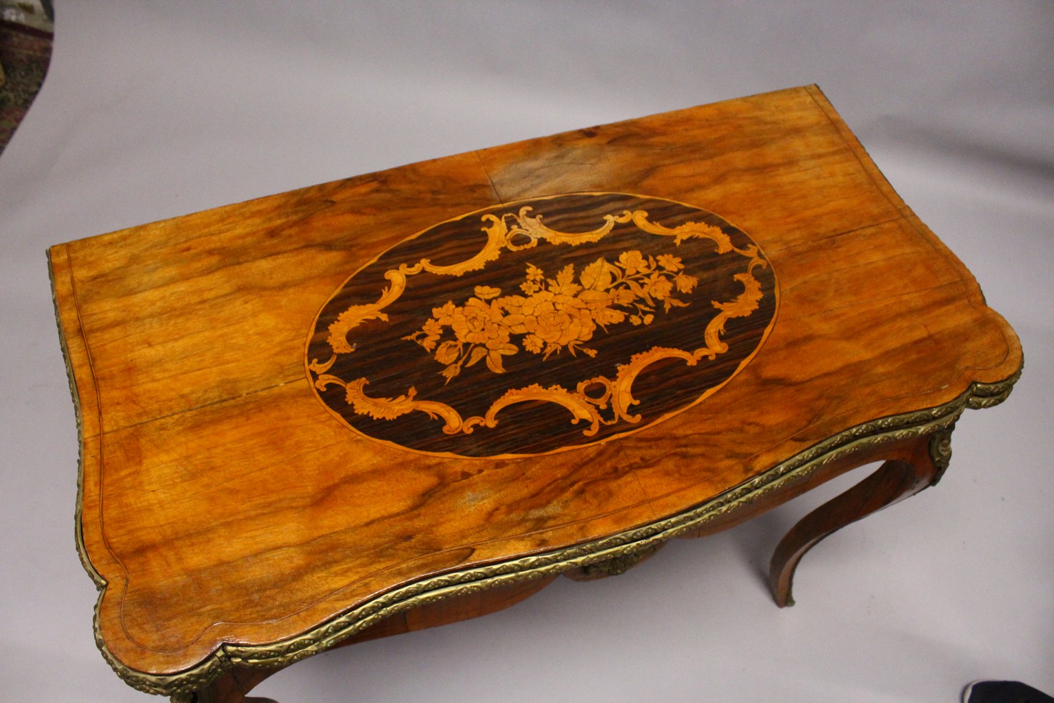 A 19TH CENTURY FRENCH WALNUT, MARQUETRY AND ORMOLU CARD TABLE, with serpentine folding top, shaped - Image 3 of 5