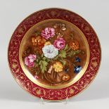 A GERMAN PORCELAIN CIRCULAR PLATTER, painted with flowers after Cornelis de Heem. 12ins diameter.