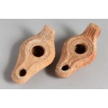 TWO SMALL TERRACOTTA OIL LAMPS.