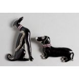 TWO SILVER AND BLACK ENAMEL DOG BROOCHES.