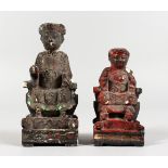 TWO SMALL CHINESE CARVED WOOD AND PAINTED SEATED FIGURES. 4.25ins and 5.5ins high.