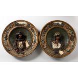 A PAIR OF LATE 19TH CENTURY CONTINENTAL POTTERY CHARGERS, moulded decoration with the bust of a