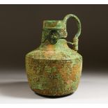 A BYZANTINE BRONZE FLASK with three sheet metal medallions decorating the neck. 8ins high.