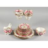 A TEA SET, with gilt decoration painted with roses, comprising seven cups, seven