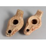 TWO SMALL TERRACOTTA OIL LAMPS.