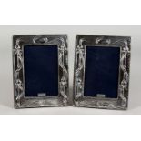 A PAIR OF ART NOUVEAU STYLE SILVER PHOTO FRAMES. 7.5ins x 5.75ins.