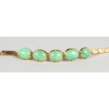 AN 18CT GOLD FIVE-STONE JADE BRACELET, in a green pouch.