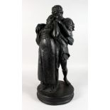 A LARGE PAINTED PLASTER GROUP, of young lovers embracing, on a circular base. 28ins high.