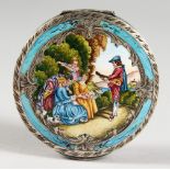 AN ENGRAVED SILVER AND ENAMEL DECORATED CIRCULAR COMPACT. 2.75ins diameter.