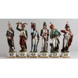 A SET OF SIX CONTINENTAL PORCELAIN MILITARY FIGURES. 11.5ins high.