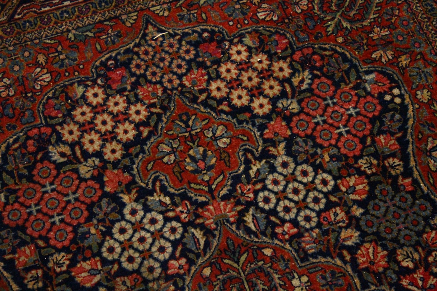 A KASHAN RUG, 20th Century dark blue ground with allover stylized tree and flower decoration. 6ft - Image 3 of 8