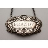 A SILVER WINE LABEL, BRANDY.