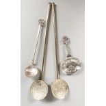 A PAIR OF STERLING SILVER GILT SPOONS, a caddy spoon and a coin spoon (4).