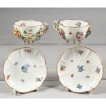 A GOOD PAIR OF MEISSEN FLOWER ENCRUSTED CUPS AND SAUCERS painted with insects. Cross swords mark