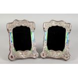 A PAIR OF ART NOUVEAU STYLE SILVER AND ENAMEL PHOTOGRAPH FRAMES, embossed with butterflies. 8ins x