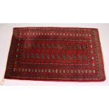 A MODERN BOKHARA STYLE RUG, red ground with two rows of thirteen gulls. 5ft 1ins x 3ft 2ins.