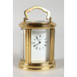 A VERY GOOD SMALL ASPREY FRENCH OVAL CARRIAGE CLOCK, with white dial, black Roman numerals and