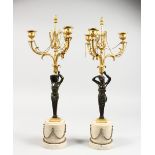 A VERY GOOD PAIR OF EMPIRE BRONZE ORMOLU CANDELABRA, as bronze classical figures, holding three