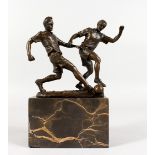 MILO A bronze of two men playing football. Signed, on a marble base. 9ins high overall.