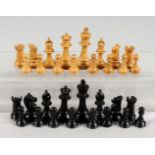A MINIATURE SET OF POSSIBLE STAUNTON PLAIN WOOD AND BLACK CHESS MEN. King: 6.25ins high.