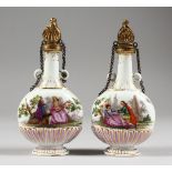 A GOOD SMALL PAIR OF 18TH CENTURY MEISSEN SCENT BOTTLES, painted with scenes of young lovers.