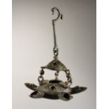 A BYZANTINE BRONZE LAMP with six nozzles and suspension chain. 7.5ins wide.