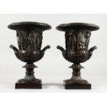 A GOOD PAIR OF CLASSICAL STYLE BRONZE CAMPAGNA FORM URNS, on square bases. 12ins high.
