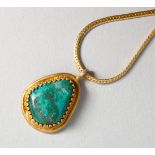 A GILDED MALACHITE PENDANT AND CHAIN.