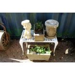 A small garden table, garden planters and ornaments