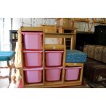 A pine toy storage rack containing six plastic boxes