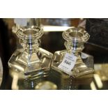 A pair of silver dwarf candlesticks with hexagonal bases