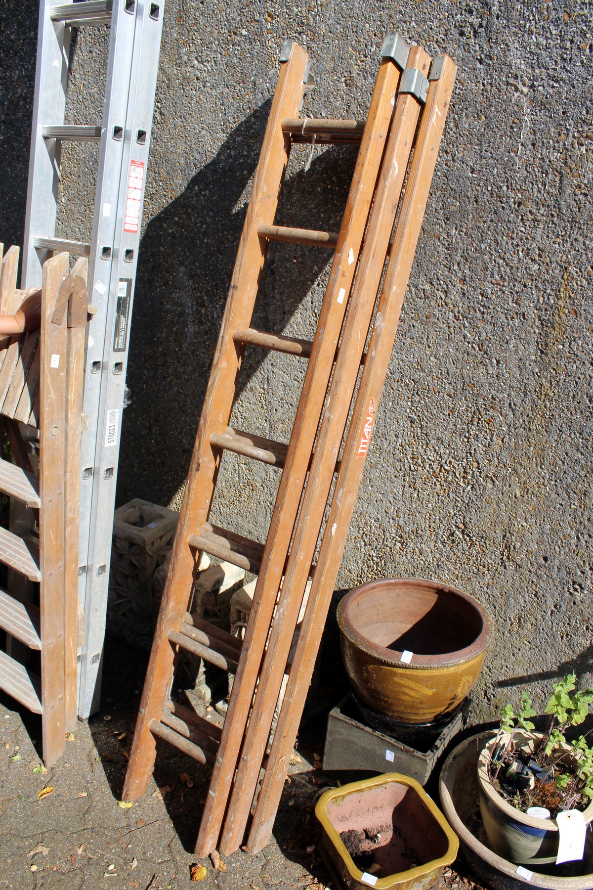 A small wooden three section ladder