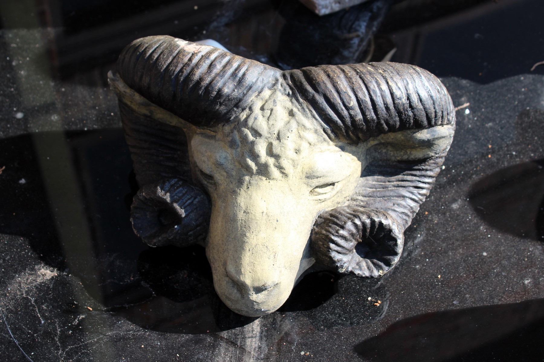 A pottery wall pocket modelled as a rams head