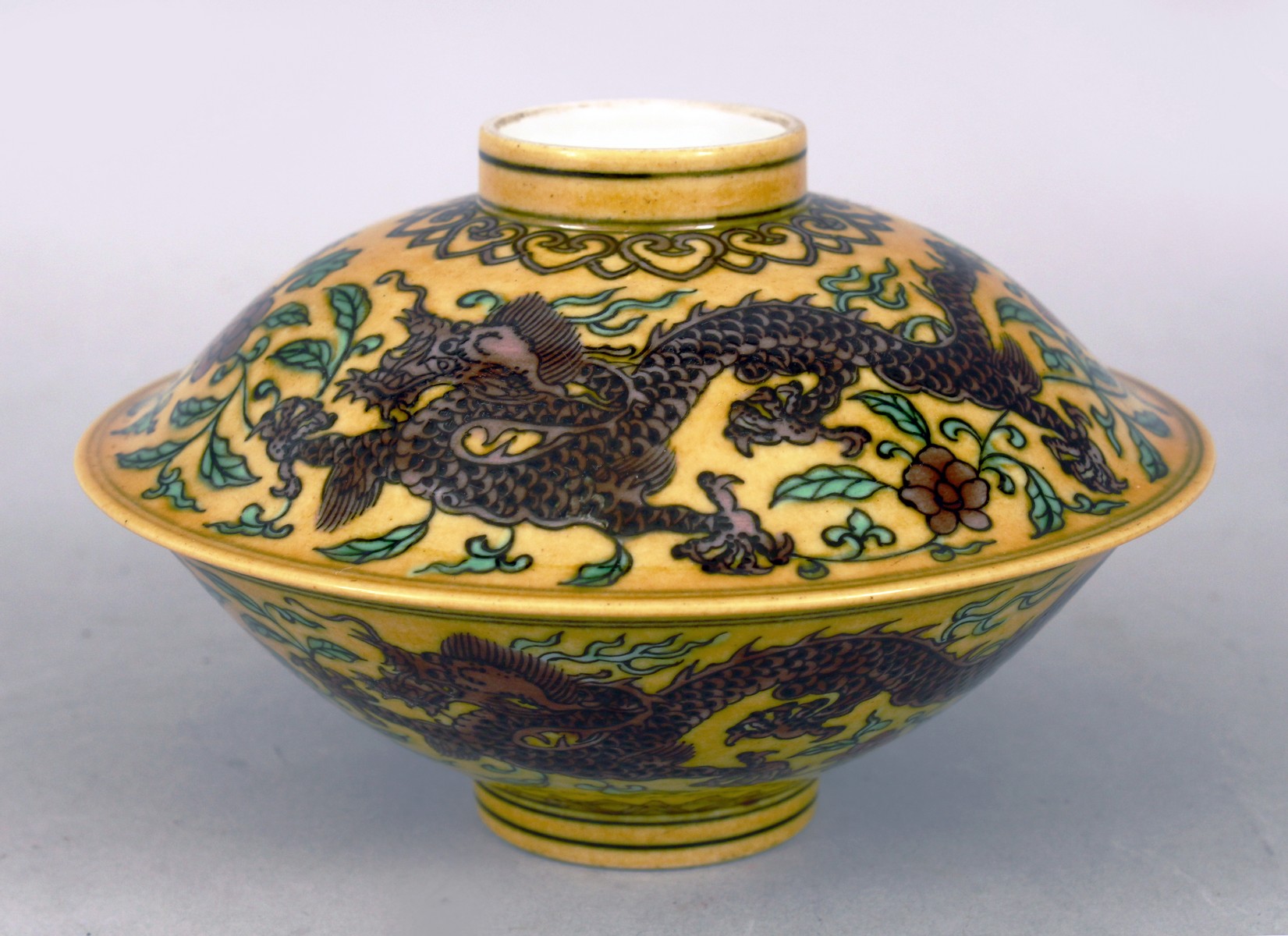 A Chinese famille joune porcelain dragon bowl and cover