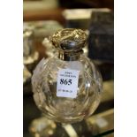 A cut glass and silver mounted scent bottle