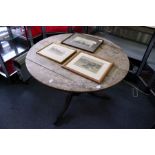 An oak circular tilt top tripod table