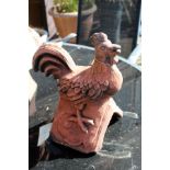 A terracotta ridge tile modelled as a chicken