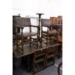 A set of oak and leather upholstered dining chairs, two with arms