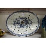 An early 20th century Chinese blue and white dragon decorated strainer