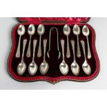 A cased set of silver coffee spoons with sugar tongs