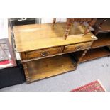 An oak two drawer side table with turned legs and untier