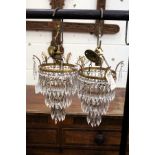 A good pair of brass and cut glass bag chandeliers