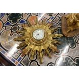 A giltwood sunburst wall clock