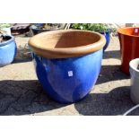 A large turquoise glazed garden pot