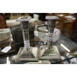 A good pair of silver cluster column candlesticks on stepped bases
