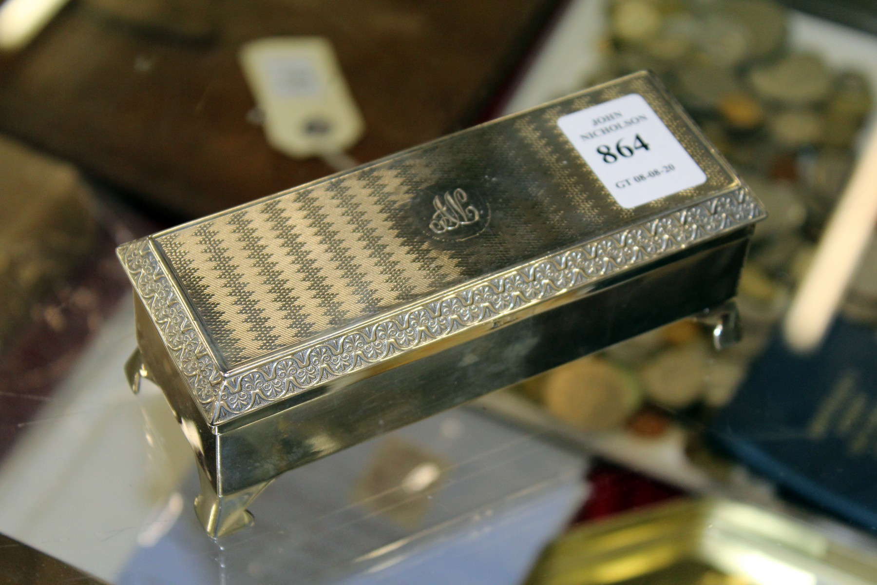 A rectangular silver box with engine turned lid