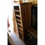 A pair of oak tall narrow bookcases