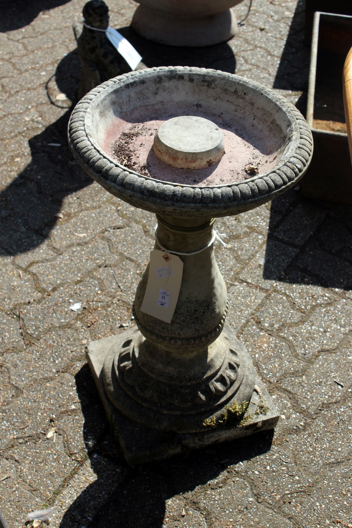 A classical style reconstituted stone bird bath